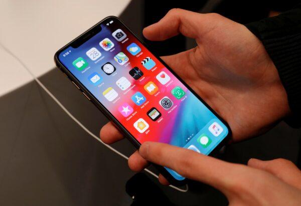 A customer tests a smartphone during the launch of the new iPhone XS and XS Max sales at "re:Store" Apple reseller shop in Moscow on Sept. 28, 2018. (Tatyana Makeyeva/Reuters)
