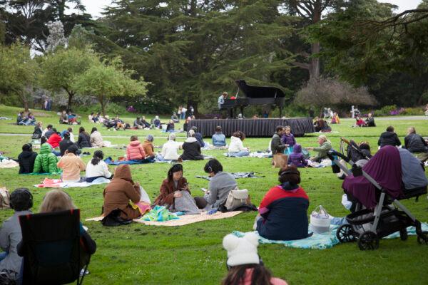 Visitors enjoy the grounds of the San Francisco Botanical Gardens while listening to a concert by Hunter Noack. (Lear Zhou/The Epoch Times)