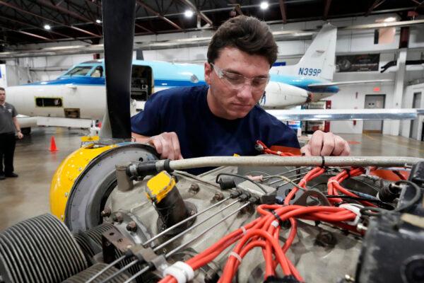 Student William Onderdork studies an engine on a Cessna 310 aircraft at Pittsburgh Institute of Aeronautics in West Mifflin, Pa., on May 2, 2023. (Gene J. Puskar/AP Photo)