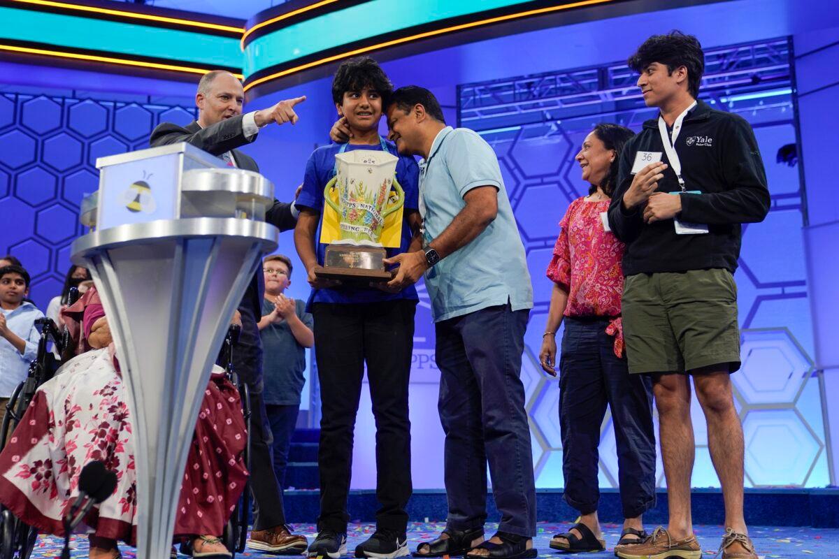 Dev Shah, 14, from Largo, Fla., celebrates winning the Scripps National Spelling Bee alongside his family in Oxon Hill, Md., on June 1, 2023. (Nathan Howard/AP Photo)