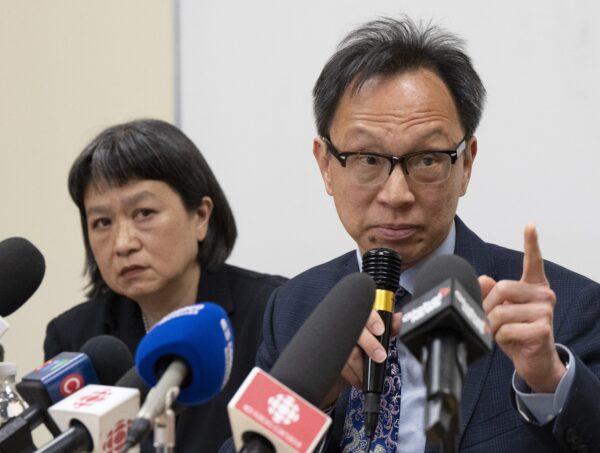 Sen. Yuen Pau Woo denounces RCMP allegations of interference by the Chinese regime in Canada as community organizer May Chiu looks on, during a news conference at the Chinese Family Service Centre in Montreal on May 5, 2023. (The Canadian Press/Ryan Remiorz)