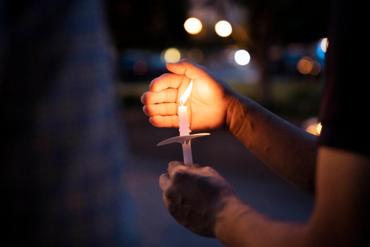 A person holds a candle at a candlelight vigil mourning the victims of the 1989 Tiananmen Square massacre in Washington on June 2, 2023. (Madalina Vasiliu/The Epoch Times)