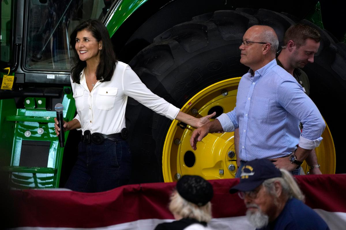 Republican presidential candidate and former U.N. Ambassador Nikki Haley walks to the stage with her husband, Michael, at an event in Des Moines, Iowa, on June 3, 2023. (Charlie Neibergall/AP Photo)