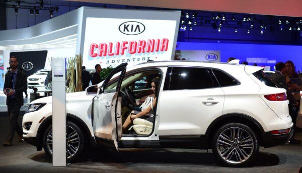 People try out the interior of a 2015 Lincoln MKC on display at the LA Auto Show's press and trade day in Los Angeles, California, on November 19, 2014. (Frederic J. Brown/AFP via Getty Images)