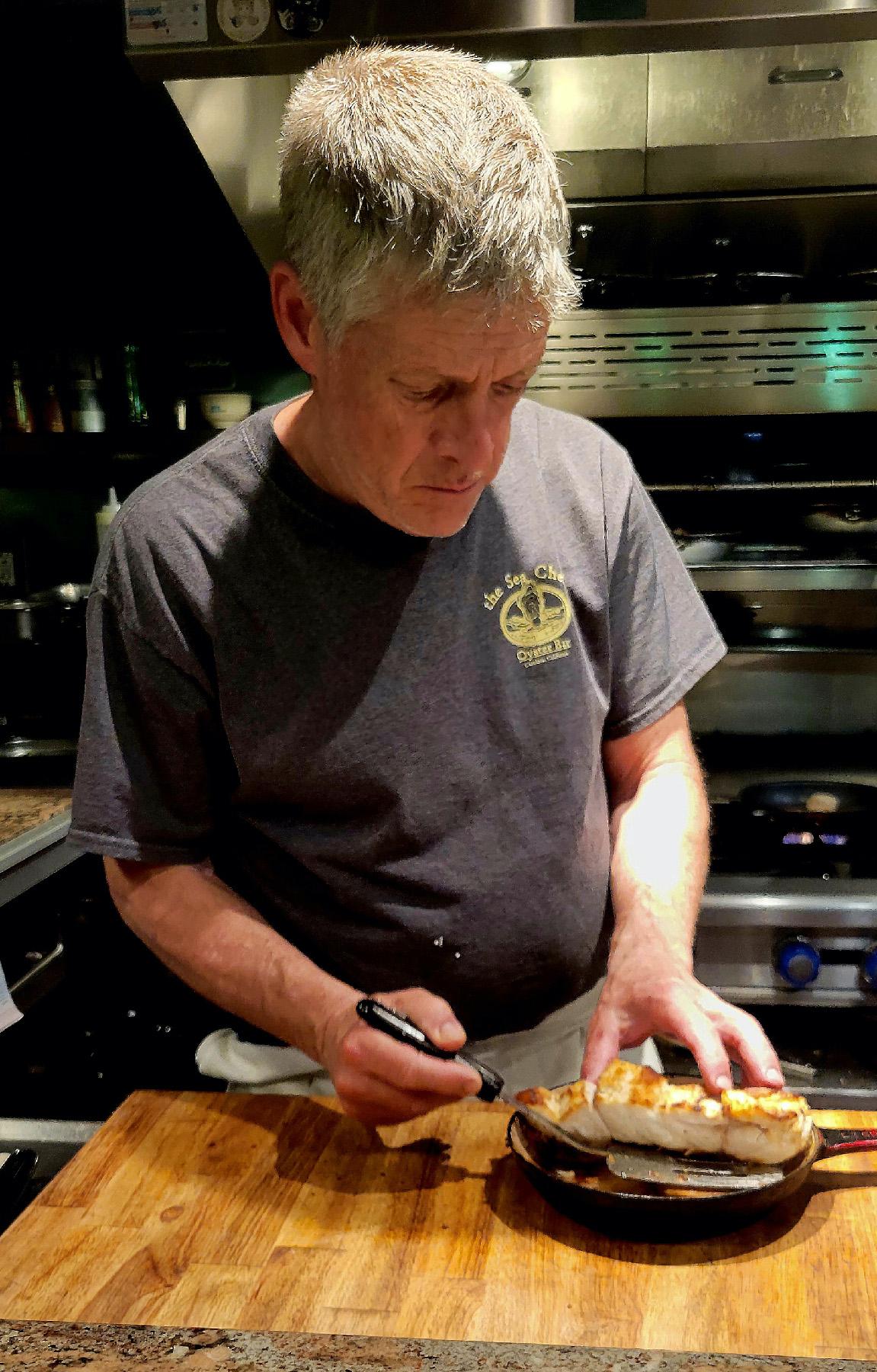 Chef Steven Kniffen serves up a fresh seafood dinner at the Sea Chest Oyster Bar in Cambria, Calif. (Courtesy of Jim Farber)