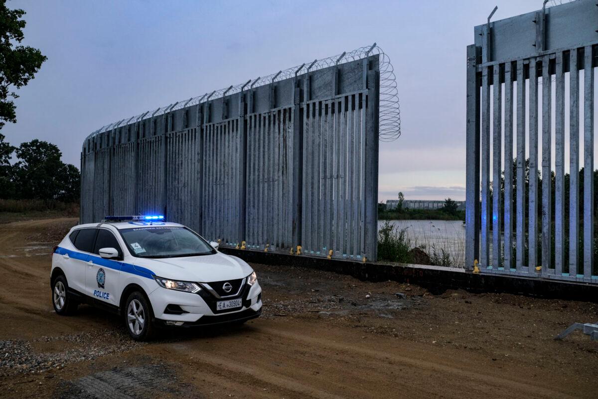 Hellenic police patrol the new 5-meter steel fence installed along the Evros River in Poros, Greece, on June 13, 2021. (Byron Smith/Getty Images)