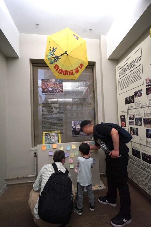 People who came to visit the exhibition also brought their children along on June 3, 2023. (Jenny Zeng/The Epoch Times)