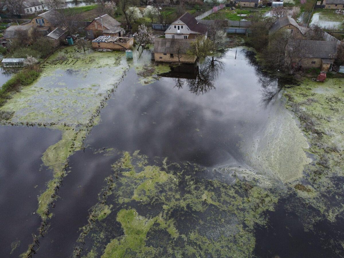 Homes are surrounded by flood waters in the small Ukrainian town of Demydiv on April 30, 2022. The settlement's dam was hit by Russian missiles. (Nicolas Garcia/AFP via Getty Images)