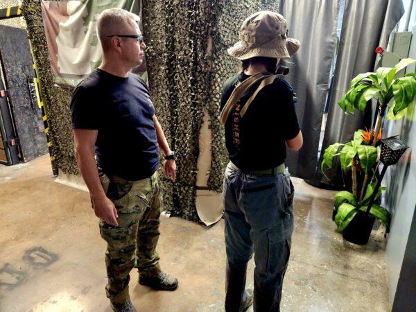 Arizona Tactical Adventures Director Mike Simpson instructs a female student in the correct position of an AR-15 on June 3, 2023. (Allan Stein/The Epoch Times)