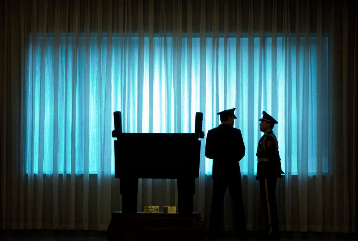 China's People's Liberation Army officers stand in front of a window before a welcome ceremony for U.S. Army Chief of Staff General Mark Milley at the Bayi Building in Beijing, on Aug. 16, 2016. (Mark Schiefelbein/AFP via Getty Images)