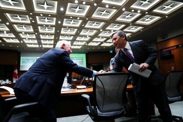 Conservative MP Michael Chong shakes hands with David Johnston, special rapporteur on foreign interference, who appears as a witness at the Procedure and House Affairs Committee on Parliament Hill in Ottawa on June 6, 2023. (Sean Kilpatrick/The Canadian Press)