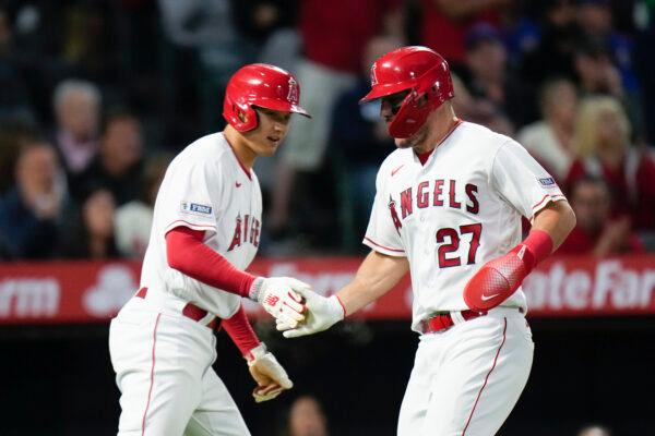 Los Angeles Angels' Shohei Ohtani, left, and Mike Trout celebrate after they scored on single by Matt Thaiss during the fifth inning of the team's baseball game against the Chicago Cubs in Anaheim, Calif., on Tuesday, June 6, 2023. (Jae C. Hong/AP Photo)