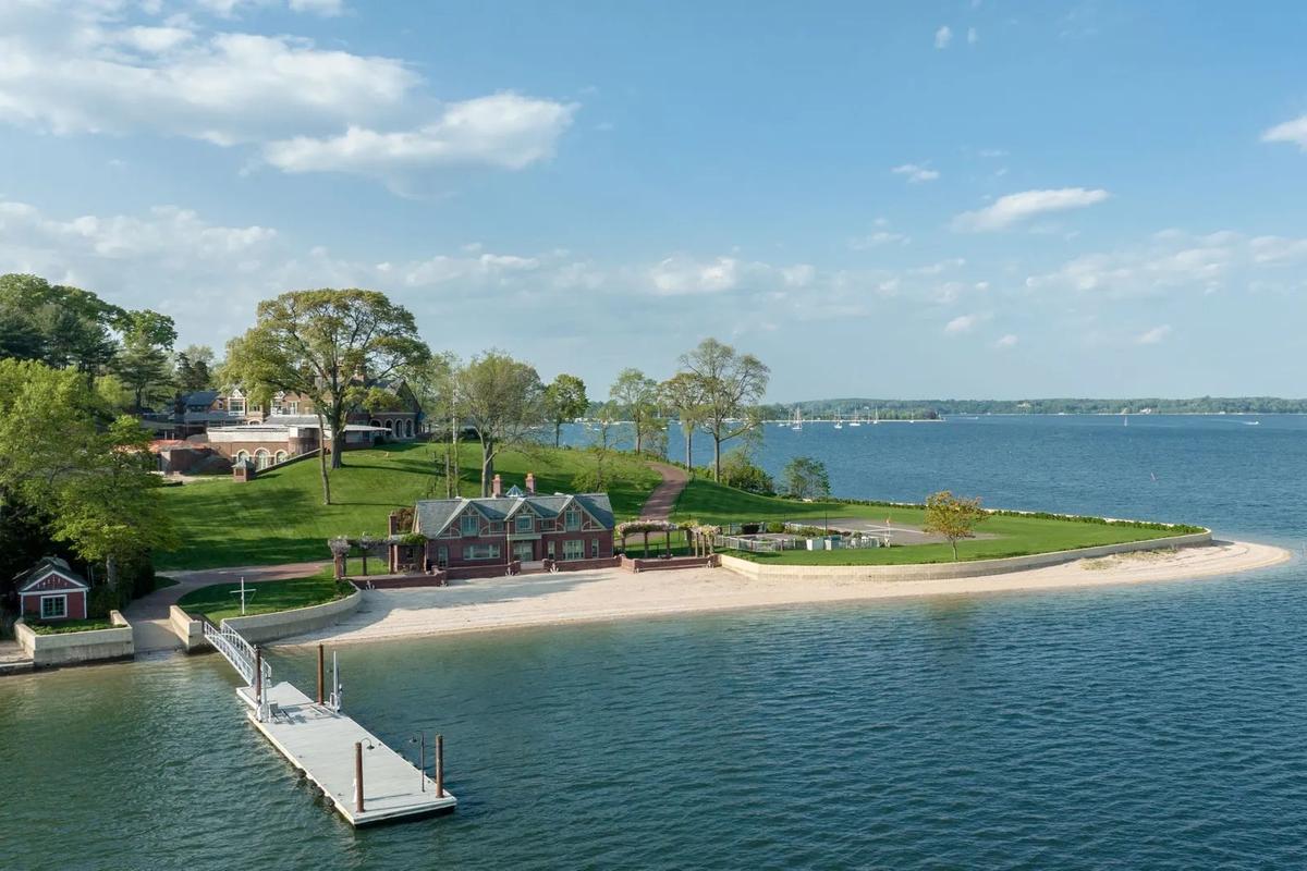 Set on a hill, the main residence looks out over the outdoor pool and helipad, a beachhouse, a boat ramp, floating docks, and Oyster Bay. (Courtesy of Tyler Sands/Daniel Gale, Sotheby’s International Realty)