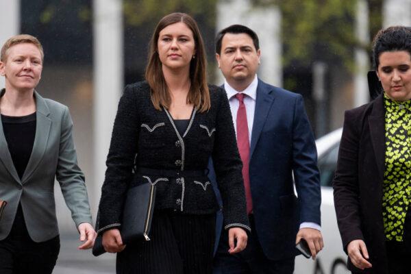 Brittany Higgins (with David Sharaz) arrives to give evidence in front of an ACT Supreme Court jury on the third day of the trial of her alleged rapist, Bruce Lehrmann, in Canberra, Australia, on Oct. 6, 2022. (Martin Ollman/Getty Images)