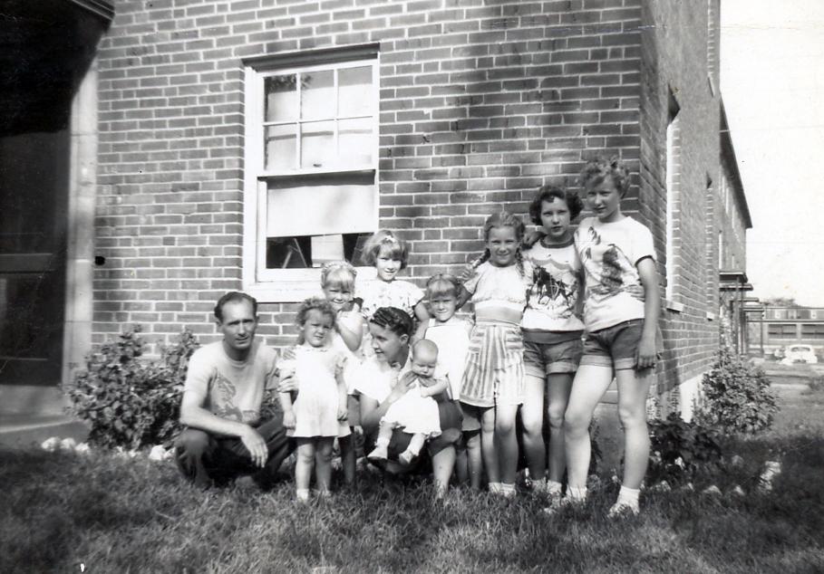 (L-R): Robert Lane (39), Kay (2), Lucy Lane (33), Barbara (3 months), Mickey (6), Bobby (9), Vicky (6), Annie (10), Ellen (15), Ruth (16), and Laverne in Dillon Drive, St. Louis in 1951. (Courtesy of Barbara Lane)