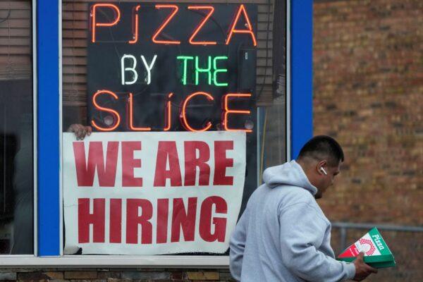 A hiring sign is displayed at a restaurant in Prospect Heights, Ill., on April 4, 2023. (Nam Y. Huh/Reuters)