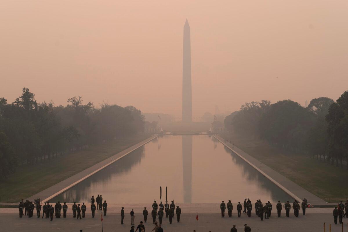 With the Washington Monument in the background amid a thick layer of smoke, a Marine Corps honor color guard rehearses in Washington on June 8, 2023. (Jose Luis Magana/AP Photo)