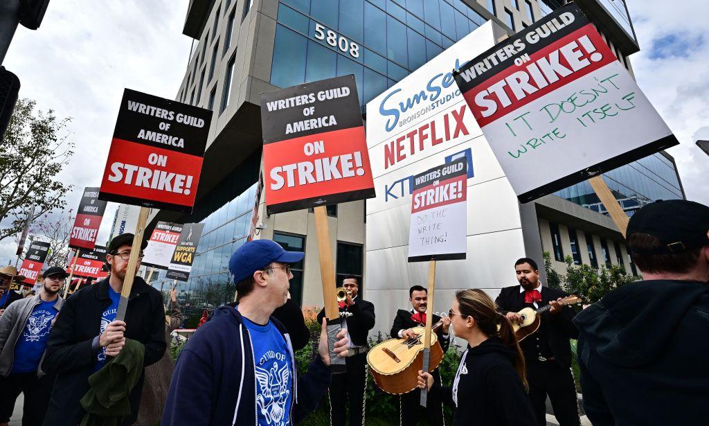 Writers on strike march with signs on the picket line on day four of the strike by the Writers Guild of America in front of Netflix in Hollywood, Calif., on May 5, 2023. (Frederic J. Brown/AFP via Getty Images)