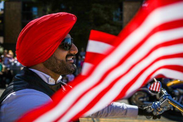 A Sikh man rides on a motorcycle with the "Sikh Riders of America" group during the 4th of July Parade in Alameda, Calif., on July 4, 2016. (Gabrielle Lurie/AFP via Getty Images)
