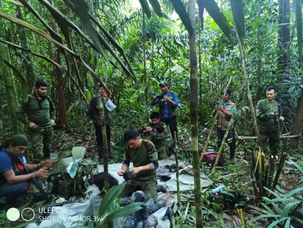 Colombian military soldiers attend to child survivors from a Cessna 206 plane that crashed on May 1 in the jungles of Caqueta, in limits between Caqueta and Guaviare, Colombia, on June 9, 2023. (Colombian Military Forces/Handout via Reuters)