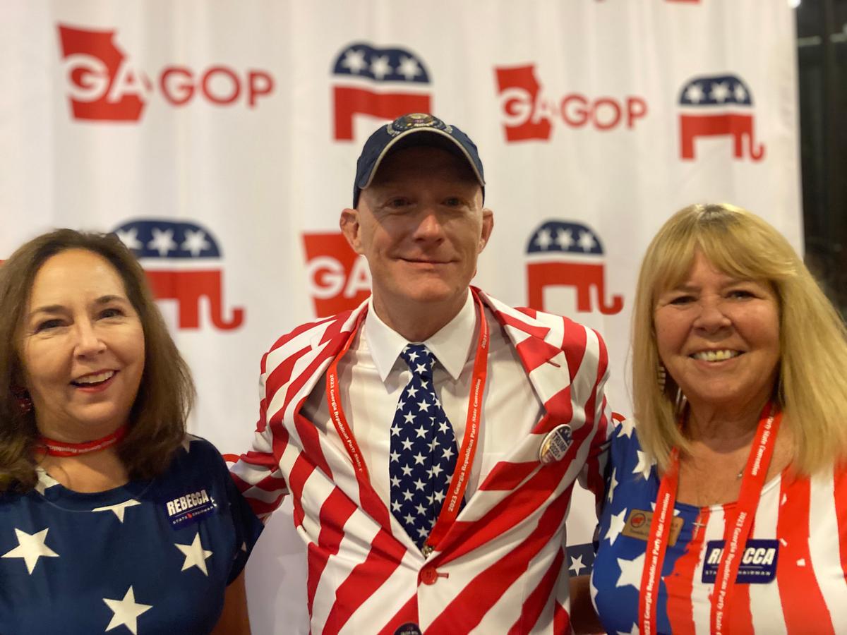 Sisters Shannon Hall (L) and Shari Poole (R) flank Cliff Rhodes (C) at the Georgia GOP Convention in Columbus, Georgia, on June 9, 2023. (Janice Hisle/The Epoch Times)