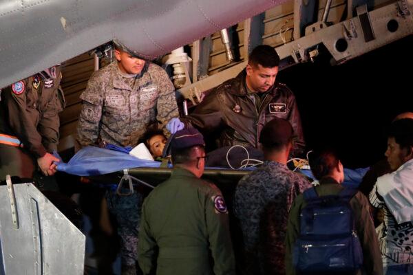 Military personnel unload from a plane one of four Indigenous children who were missing after a deadly plane crash at the military air base in Bogota, Colombia, on June 10, 2023. The children survived a small plane crash 40 days ago and had been the subject of an intense search in the jungle. (AP Photo/Ivan Valencia)