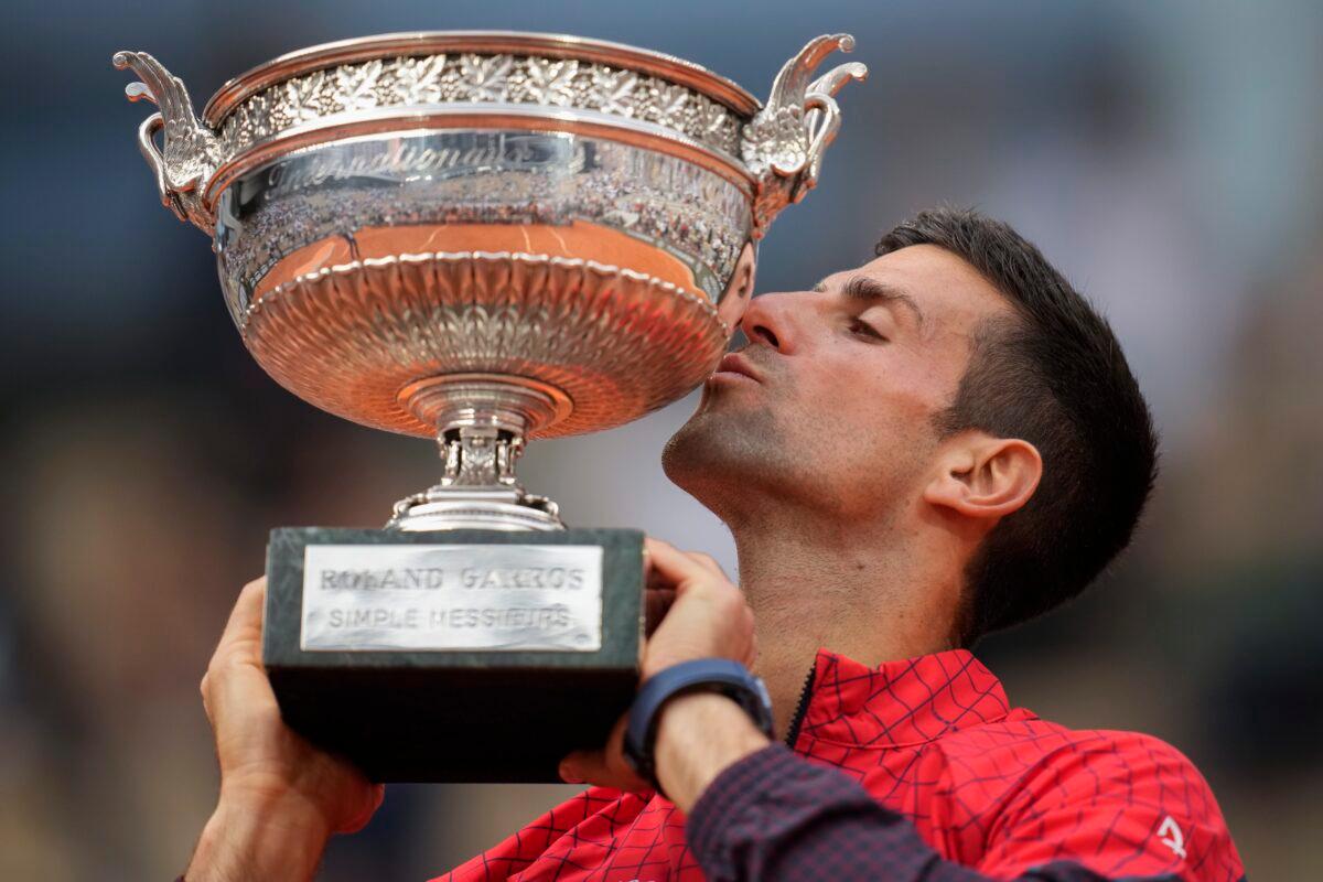 Serbia's Novak Djokovic kisses the trophy as he celebrates winning the men's singles final match of the French Open tennis tournament at the Roland Garros stadium in Paris on June 11, 2023. (Christophe Ena/AP Photo)
