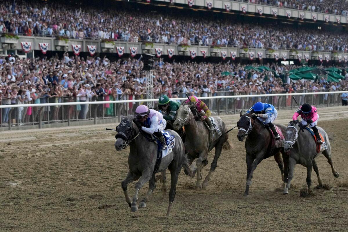 Thoroughbred racehorse Arcangelo, with jockey Javier Castellano aboard, crosses the finish line to win the 155th running of the Belmont Stakes horse race at Belmont Park in Elmont, N.Y., on June 10, 2023. (Seth Wenig/AP)