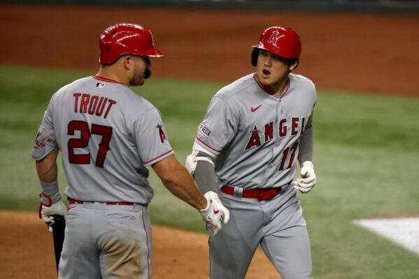 Mike Trout (L) (27) of the Los Angeles Angels congratulates Shohei Ohtani (17) of the Los Angeles Angels after his home run in the seventh inning against the Texas Rangers at Globe Life Field in Arlington, Texas, on June 12, 2023. (Tim Heitman/Getty Images)