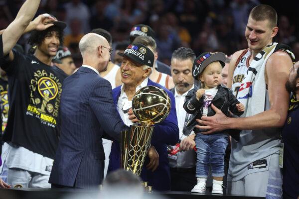 NBA Commissioner Adam Silver presents the Larry O'Brien Championship Trophy to Denver Nuggets owner Stan Kroenke after the victory against the Miami Heat in Game Five of the 2023 NBA Finals to win the NBA Championship at Ball Arena in Denver on June 12, 2023. (Matthew Stockman/Getty Images)