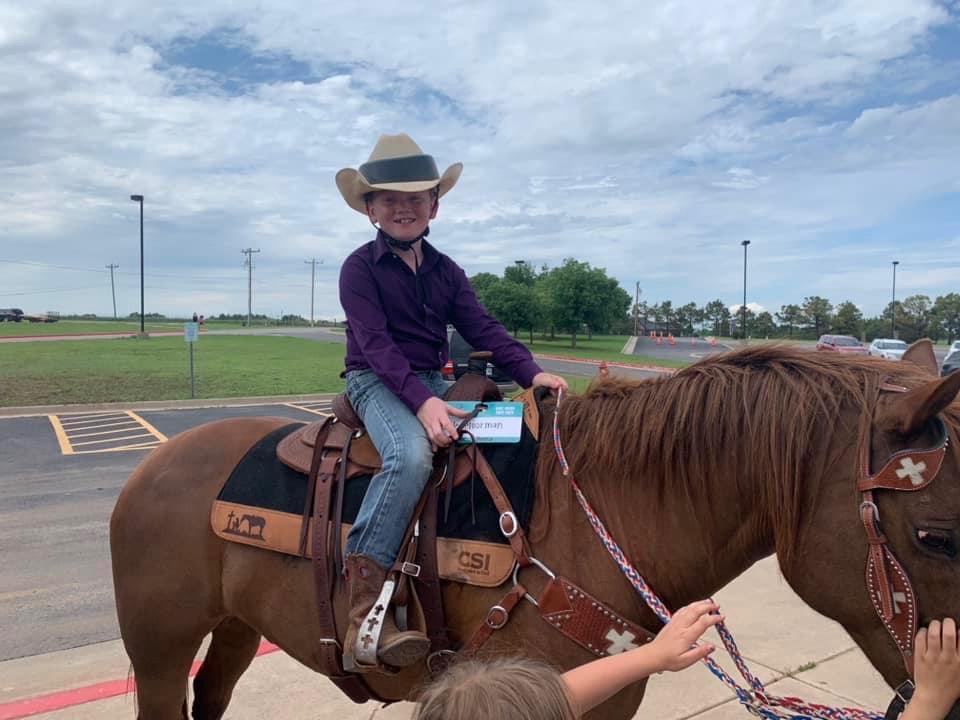 Cale on his horse with a cowboy hat helmet. (Courtesy of Deer Creek School District)