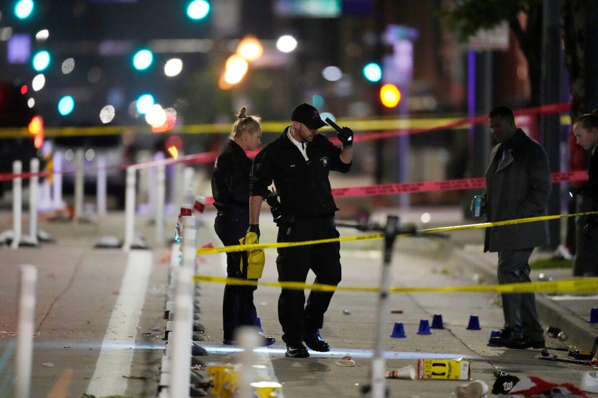 Denver Police Department investigators work the scene of a mass shooting along Market Street between 20th and 21st avenues during a celebration after the Denver Nuggets won the team's first NBA Championship in Denver on June 13, 2023. (David Zalubowski/AP Photo)