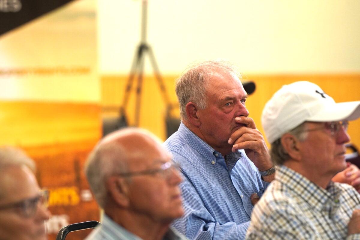 A South Dakota farmer listens at a gathering in Aberdeen, S.D., on the threat to property rights by green energy projects on June 10, 2023. (Allan Stein/The Epoch Times)
