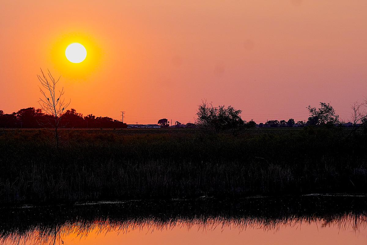 Sunset over farmland in Groton, South Dakota on June 10, 2023. (Allan Stein/The Epoch Times)
