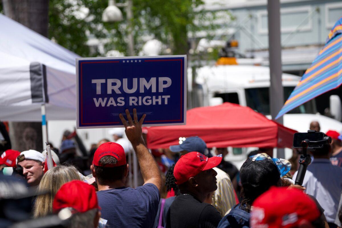 A man holds a Trump sign outside the federal courthouse in Miami on June 13, 2023. (Madalina Vasiliu/Epoch Times)