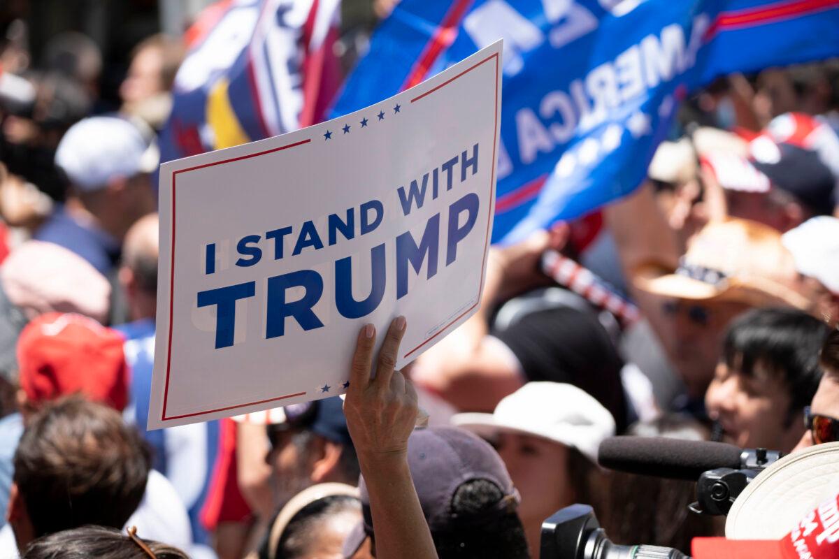 A protester holds a sign outside the federal courthouse in Miami on June 13, 2023. (Madalina Vasiliu/Epoch Times)