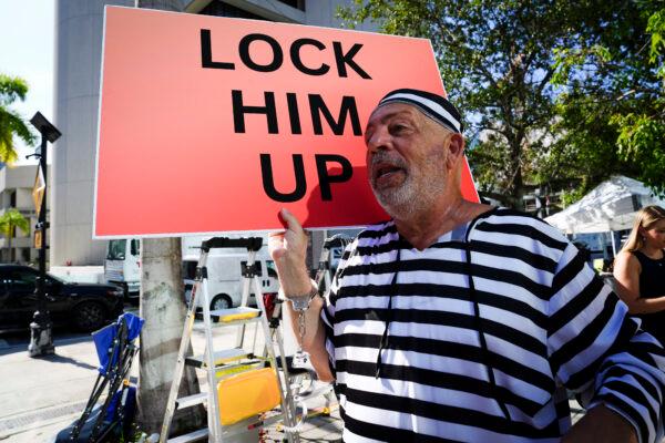 Dominic Santana, an anti-Trump protester, holds a sign outside the Wilkie D. Ferguson Jr. United States Courthouse in Miami, Fla., on June 13, 2023. (Madalina Vasiliu/The Epoch Times)