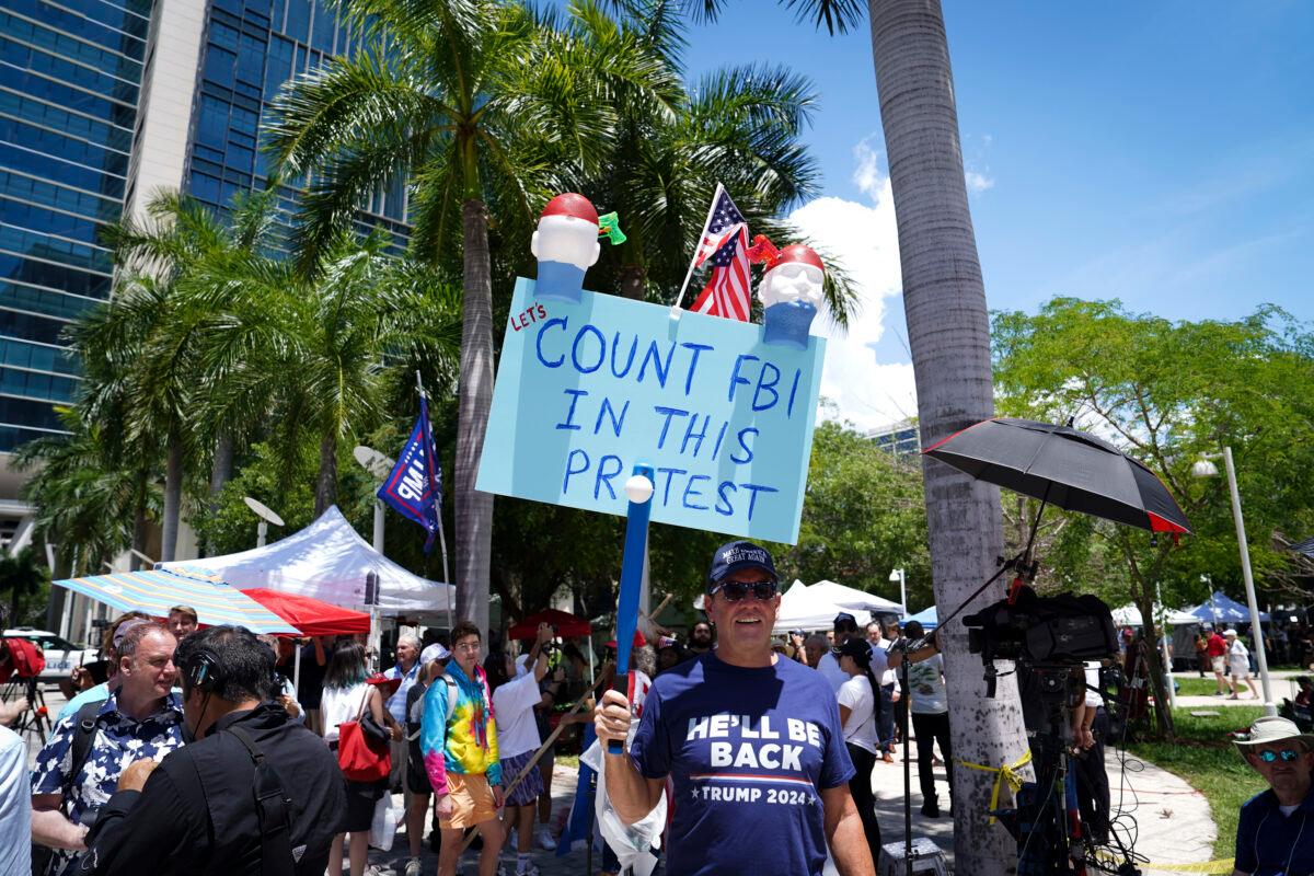 A protester holds a sign outside the Wilkie D. Ferguson, Jr. federal courthouse in Miami, Fla., on June 13, 2023. (Madalina Vasiliu/The Epoch Times)