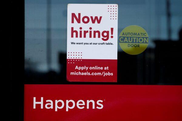 A hiring sign is displayed at a retail store in Downers Grove, Ill., on April 12, 2023. (Nam Y. Huh/AP Photo)