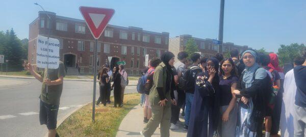 Dozens of students gather at Longfields-Davidson Heights Secondary School to protest against gender ideology, in Ottawa on June 15, 2023. (Matthew Horwood/The Epoch Times)