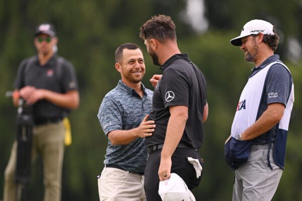 Xander Schauffele of the United States and Jon Rahm of Spain react as they finish their round on the ninth green during the first round of the 123rd U.S. Open Championship at The Los Angeles Country Club in Los Angeles on June 15, 2023. (Ross Kinnaird/Getty Images)