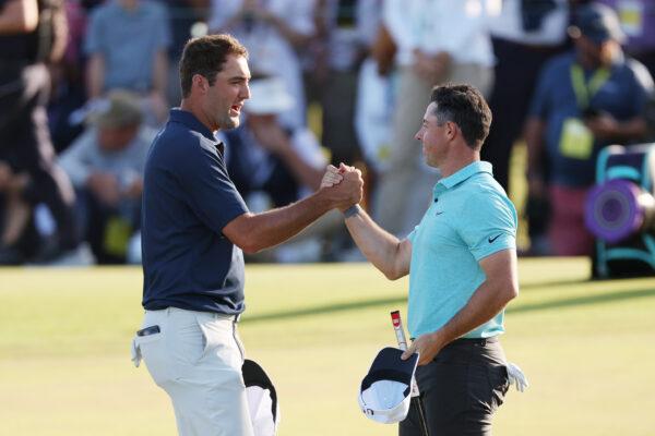 Scottie Scheffler of the United States and Rory McIlroy of Northern Ireland shake hands on the 18th green during the final round of the 123rd U.S. Open Championship at The Los Angeles Country Club in Los Angeles on June 18, 2023. (Harry How/Getty Images)