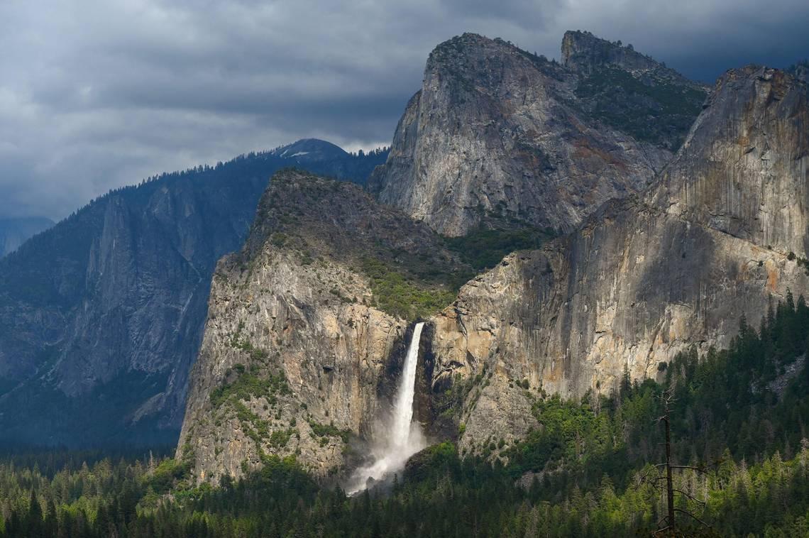 Bridalveil Fall gleams in the late afternoon sunlight as clouds form overhead in Yosemite Valley on Tuesday, June 14, 2023. (Craig Kohlruss/The Sacramento Bee/TNS)