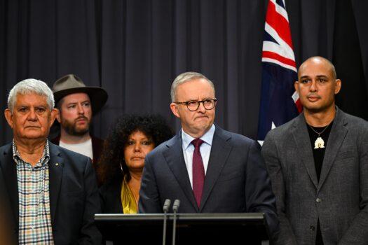 Australian Prime Minister Anthony Albanese, surrounded by members of the First Nations Referendum Working Group (Thomas Mayo to his right), speaks to the media during a press conference at Parliament House in Canberra, Australia, on March 23, 2023. (AAP Image/Lukas Coch)