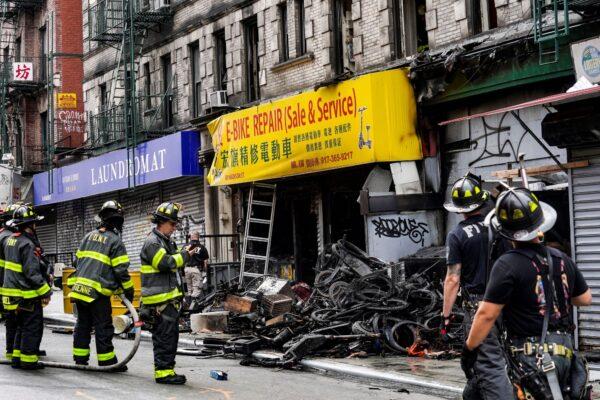 Firefighters and investigators go through the aftermath of a fire which authorities say started at an e-bike shop and spread to upper-floor apartments, in New York on June 20, 2023. (Bebeto Matthews/AP Photo)