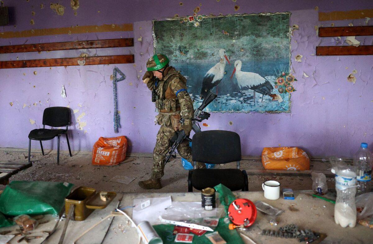 A Ukrainian serviceman walks inside a heavily damaged cultural center in the recently liberated village of Blagodatne, in the Donetsk region, on June 16, 2023, amid the Russian invasion of Ukraine. (Anatolii Stepanov/AFP via Getty Images)