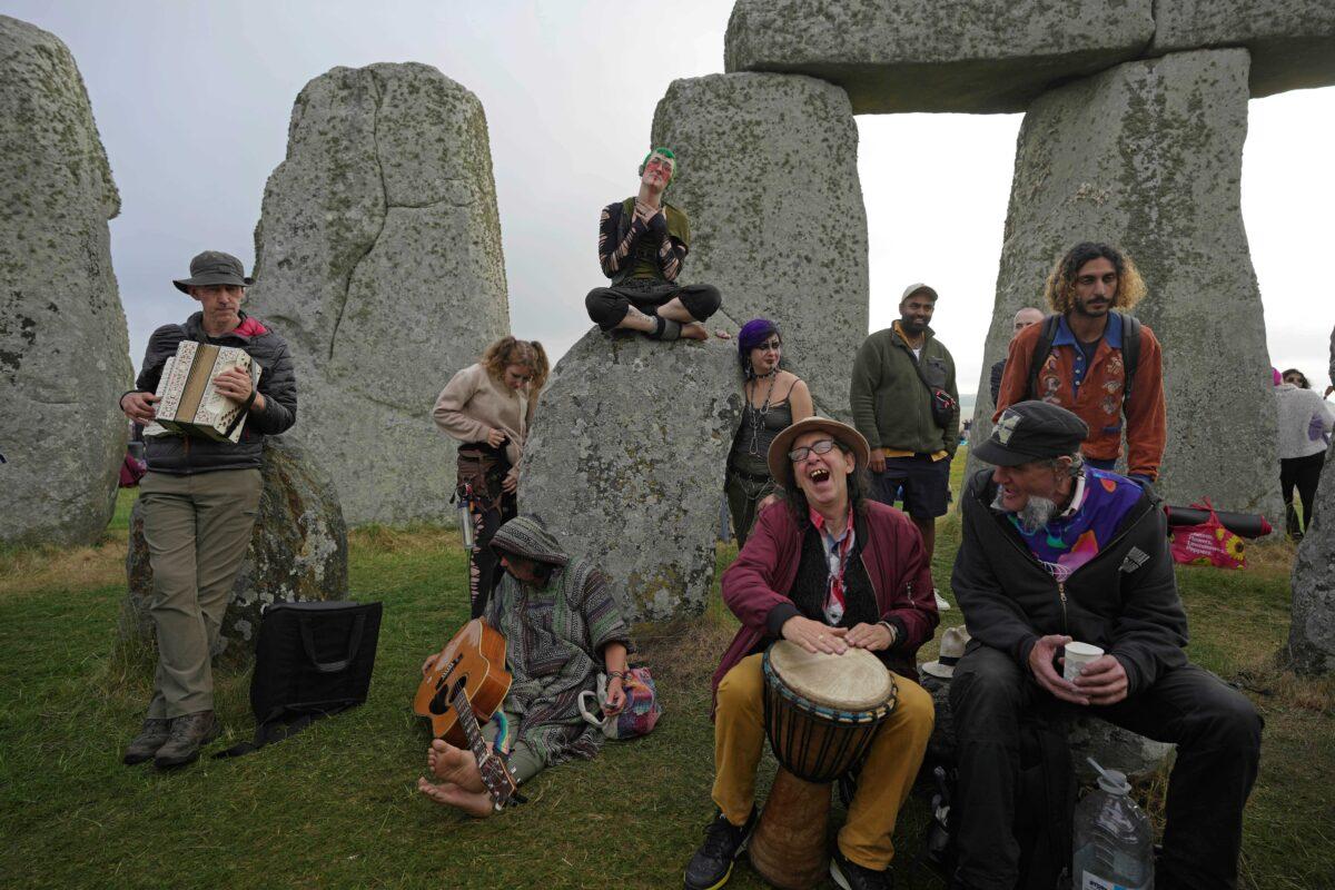 Revelers gather at the ancient stone circle Stonehenge to celebrate the Summer Solstice, the longest day of the year, near Salisbury, England, on June 21, 2023. (Kin Cheung/AP Photo)