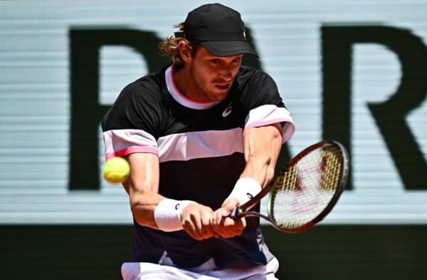 Chile's Nicolas Jarry plays a backhand return to Norway's Casper Ruud during their men's singles match on day nine of the Roland-Garros Open tennis tournament at the Court Philippe-Chatrier in Paris on June 5, 2023. (Julien De Rosa/AFP via Getty Images)