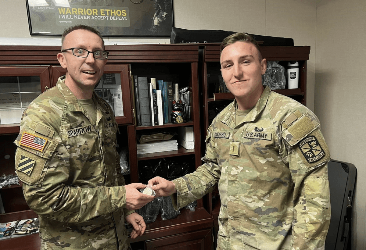 (L) Lieutenant Colonel Scott Sparrow delivers a Peace Dollar to newly commissioned Lieutenant Mark J Cuozzo. (Courtesy of Cal State Fullerton Vets and Cadets Endowed Scholarship Award)