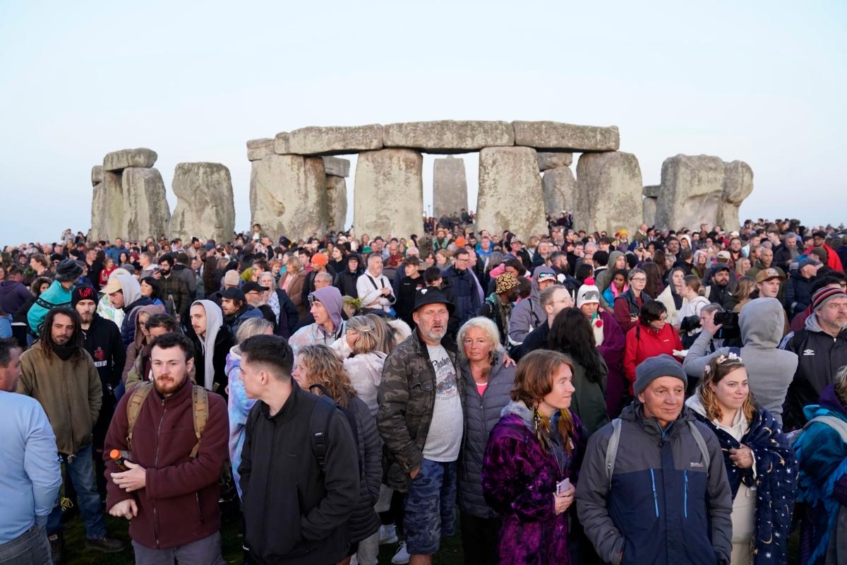 People gather during sunrise as they take part in the Summer Solstice at Stonehenge in Wiltshire, England, on June 21, 2023. (Andrew Matthews/PA via AP)
